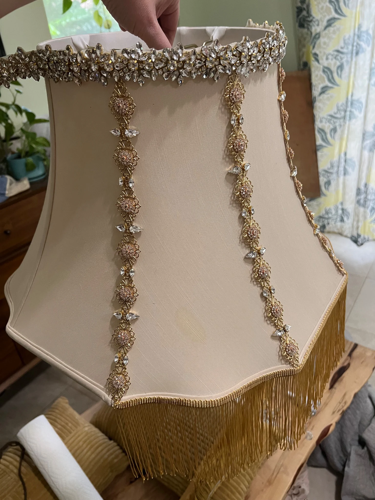 The scalloped shade decorated with crystals, jewelry, and fringe